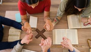 High,Angle,Of,Catholic,Young,Men,And,Women,Holding,Each