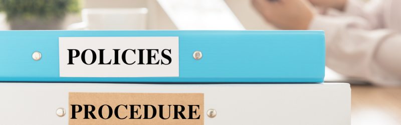 Policies,And,Procedures,Doucument,Place,On,Desk,In,Meeting,Room.
